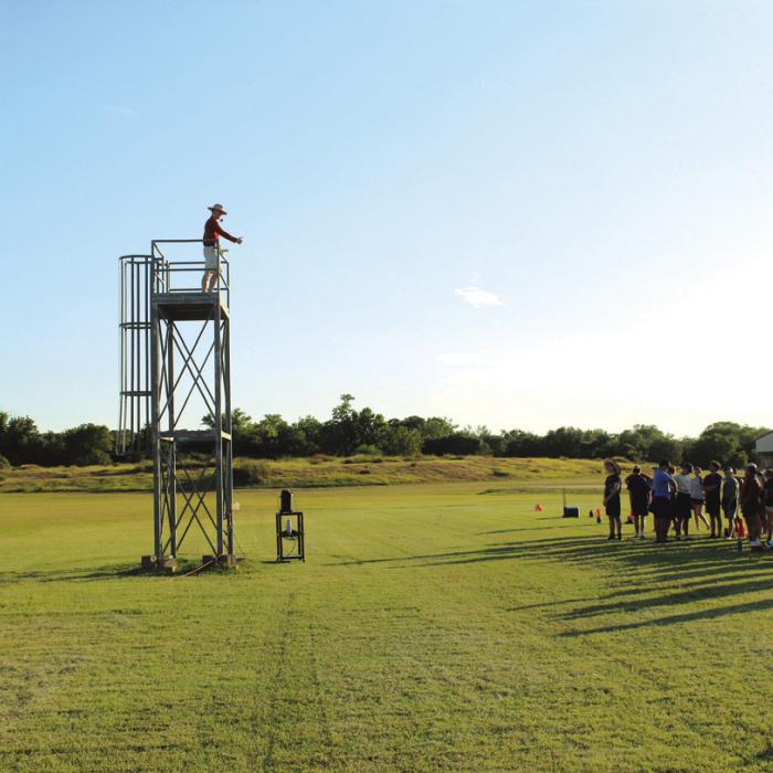 La Grange head band director Christopher Cooper addresses the band Friday from atop a viewing perch that allows him to better see the marching formations.