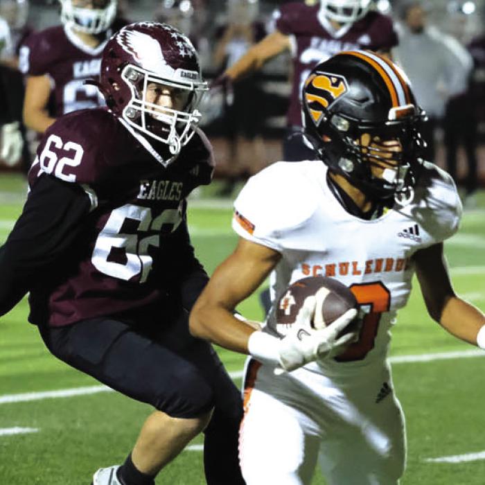 Schulenburg receiver Byron Johnson evades Johnson City defenders on his way to the endzone. Photos by Andy Behlen