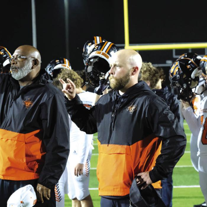 First year head coach Luke Hobbs (center) holds up a Shorthorn salute as the band plays the school song following Friday’s playoff loss to Johnson City.