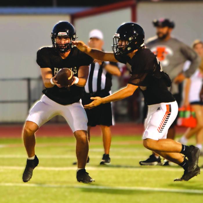Schulenburg’s Colton Richburg hands off the football in last week’s scrimmage versus Lexington. Photo by Darrell D. Gest