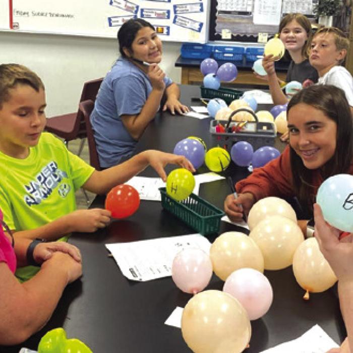 FISD 6th graders with their balloon molecules.