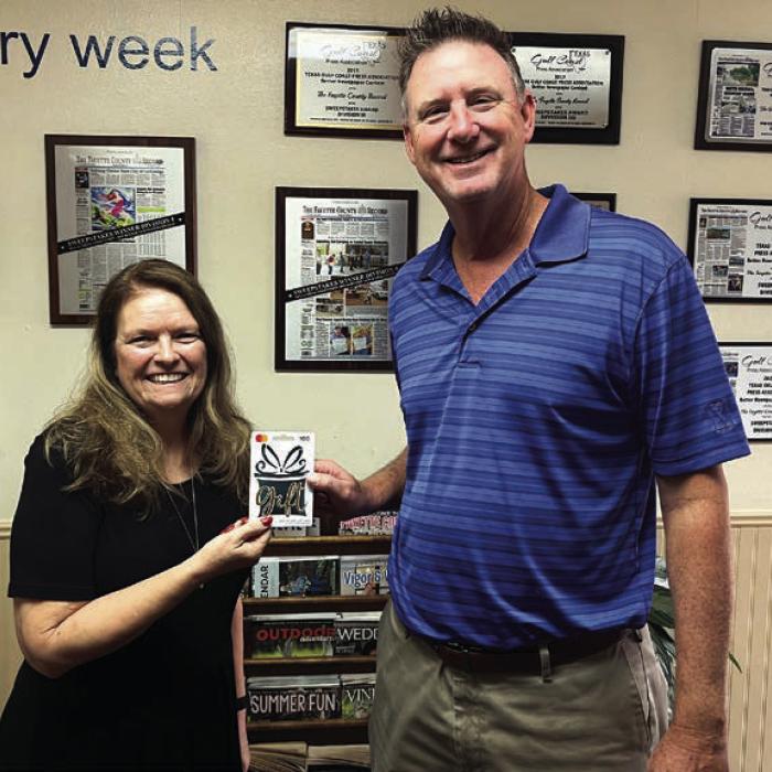 For the second time in three weeks David Cooper was the winner of The Fayette County Record’s reader football pick-it contest by correctly picking the winner of all 10 games last week. He is shown here accepting his $100 gift card from Record publisher Regina Keilers. The ballot appears in every Tuesday edition of The Record. Photo by Jeff Wick