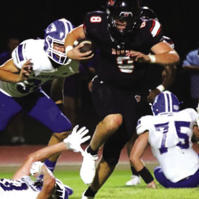 Schulenburg quarterback Owen Brenek eludes several Sacred Heart Hallettsville tacklers on his way to a big night for the Shorthorns Friday. Photo by Audrey Kristynik