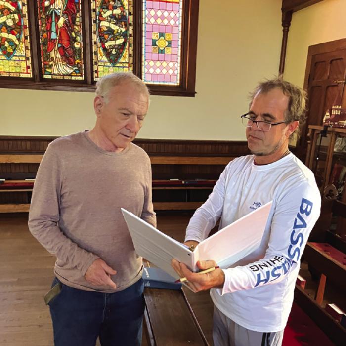 Director John Saunders (right) discussing script with congregant and veteran NPR Morning Edition commentator, Austin Bay.