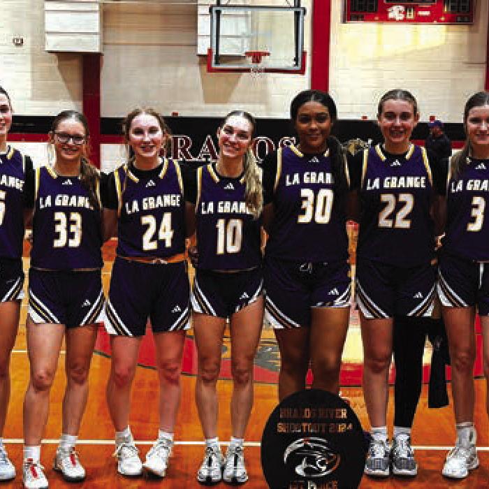 The members of the La Grange girls basketball team pose with their trophy after winning the tournament in Brazos Saturday.