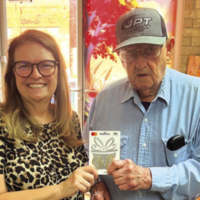 Albert Loehr, above, and Brian Cox, below, split last week’s reader football pick-it prize. Both got all 10 games right and tied on the score prediction tiebreaker. They are shown here accepting their $50 prizes from Record publisher Regina Keilers.