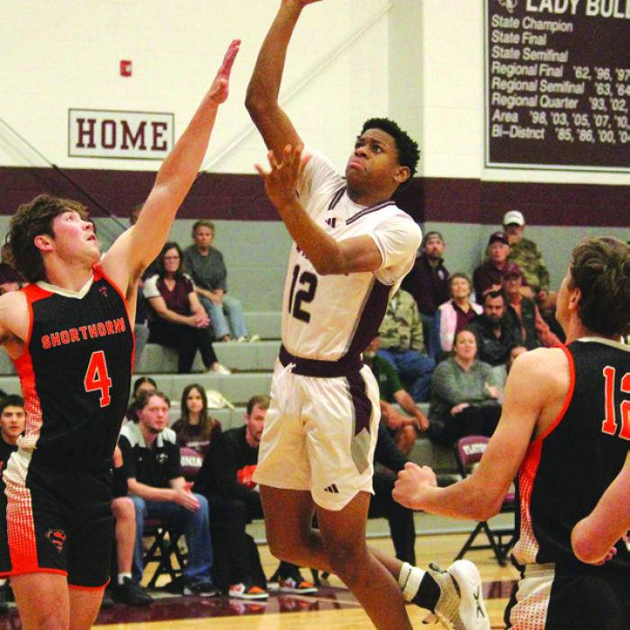 Flatonia’s Jaylon Anderson goes to the basket against the defense of Schulenburg’s Jayse Janda. Photo by Jeff Wick