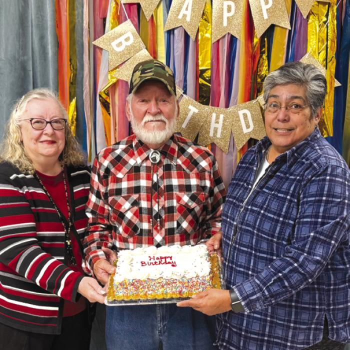 Out of 27 members celebrating birthdays in the month of February, these three braved the ice cold temperatures to get a slice of this cake brought by Cynthia Trojacek. Pictured are Kitra Ruiz and her husband Steve, and Cindy Villarreal. All of the birthday honorees will receive a birthday card signed by many members to brighten their day.