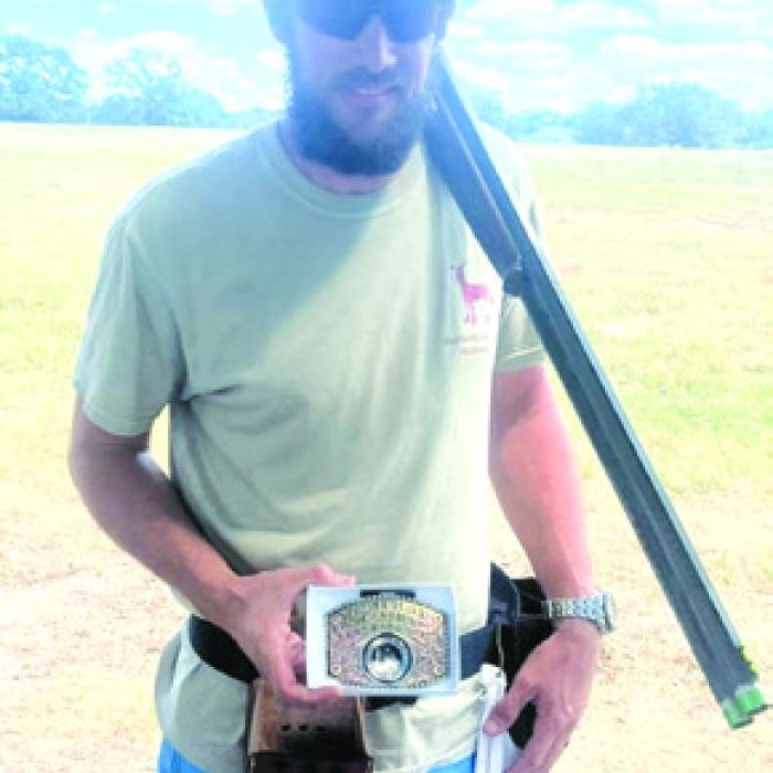 Steven McFarlin shows the buckle he won at the Clay and Turkey Shoot.