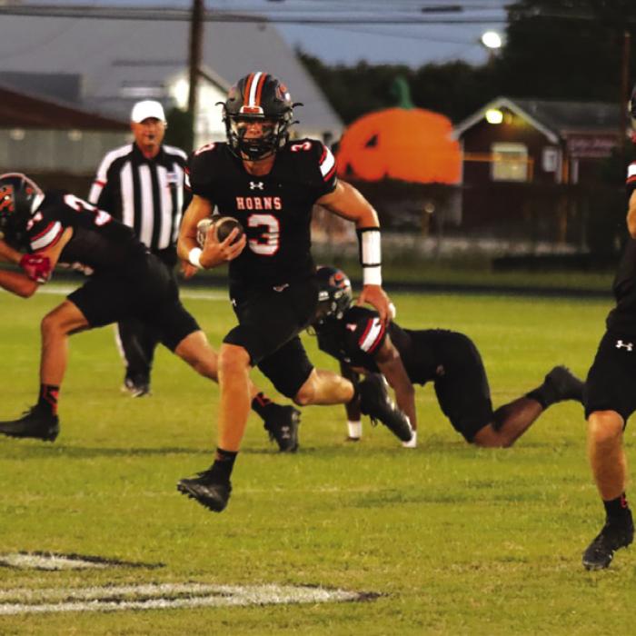 Schulenburg quarterback Aaron Janecek takes advantage of blocking to find some running room in Friday’s victory. Photo by Audrey Kristynik