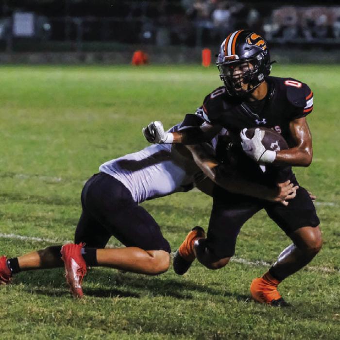 Byron Johnson fights through a tackle after catching a screen pass. Photo by Andy Behlen