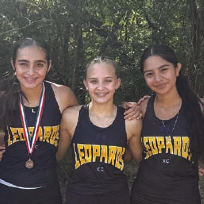 Above the La Grange varsity girls cross country team, and right, the junior varsity team, after their runs at the district meet in Caldwell Monday.