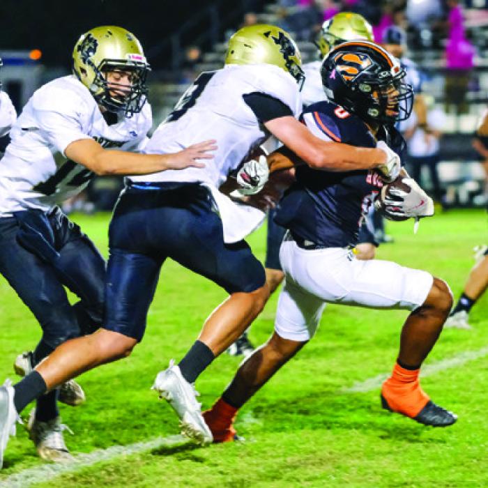 Byron Johnson fights off a pack of Danbury defenders. Photo by Andy Behlen