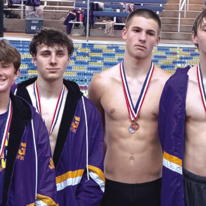 The boys relay team of Rogan Mihatsch (not pictured, but Team Manager Everett Cook is standing in for Rogan as he had to get back for a basketball game), Gavin Cook, Braxton Landis and Van Huette is advancing to regionals.
