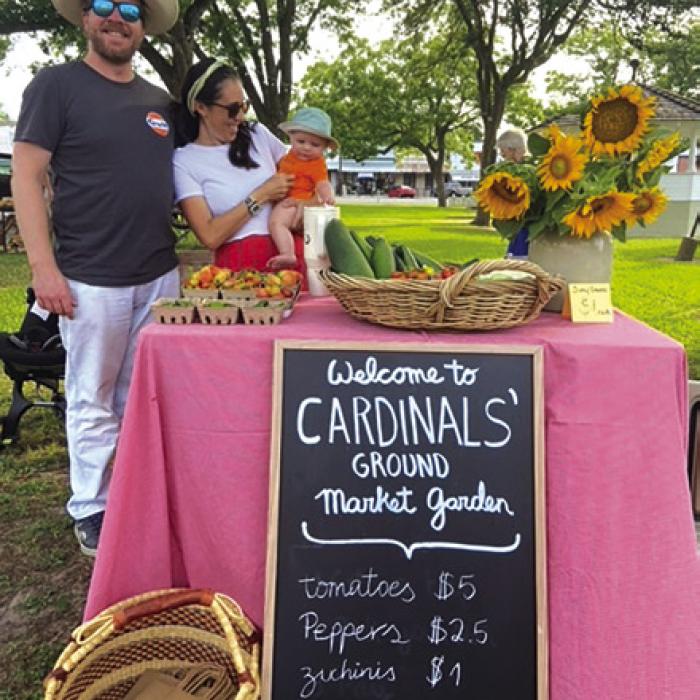 The Lummis family selling veggies.