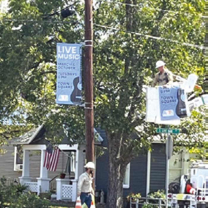 Banners being hung around town announcing ARTS music series coming up next month.