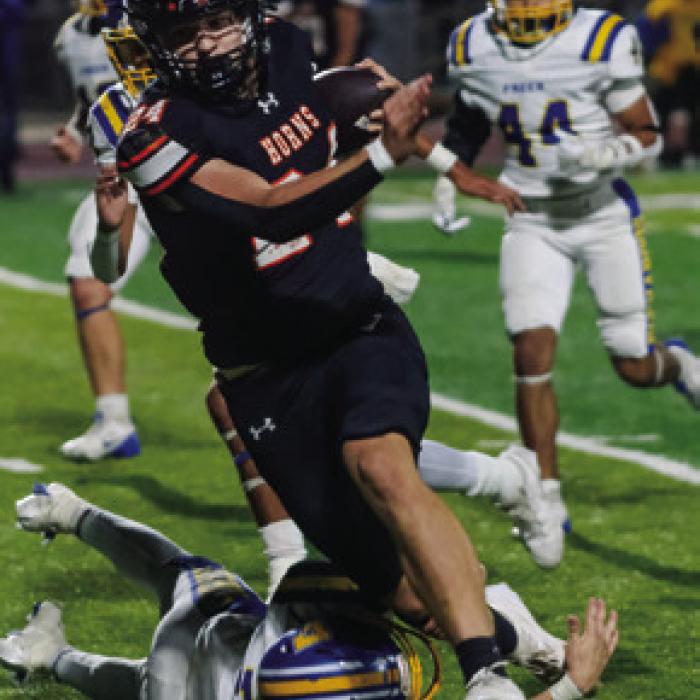 Mason Kunschick slips past a tackle. Photos by Andy Behlen