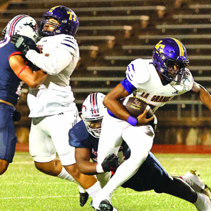 La Grange’s Le’Kayvion Broussard tries to break free Thursday as Jaiden Scott blocks. Photo by Darrell D. Gest