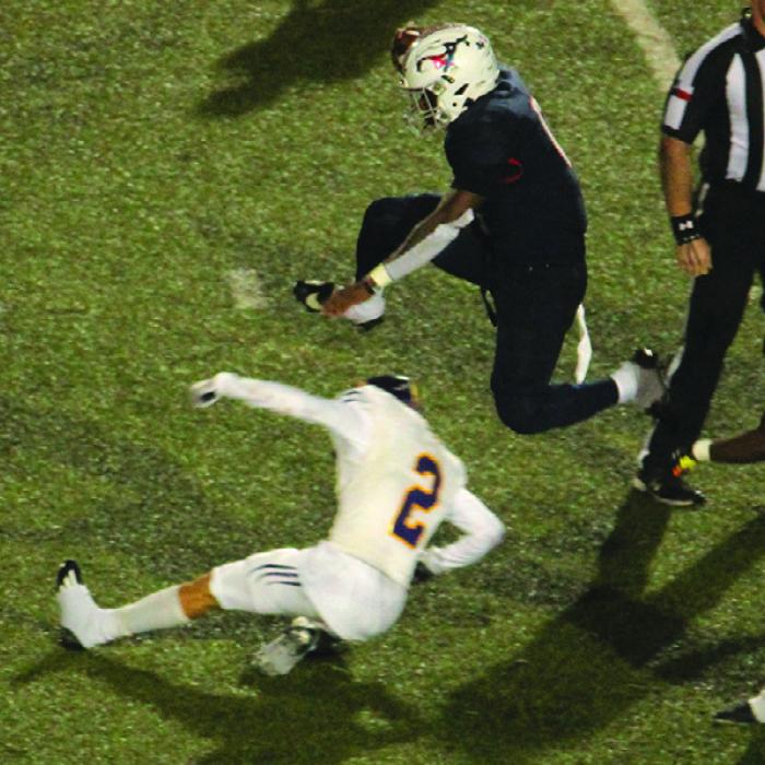 Madisonville’s Phillip Green Jr. hurdles over La Grange’s Max Dixon Thursday on his way to a three-touchdown rushing night. Photo by Jeff Wick