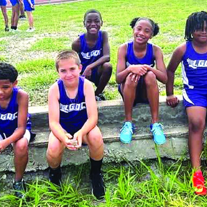 Some of the La Grange Optimist Club athletes relax during a break in action at the Flatonia meet earlier this year. La Grange Optimist Club photo