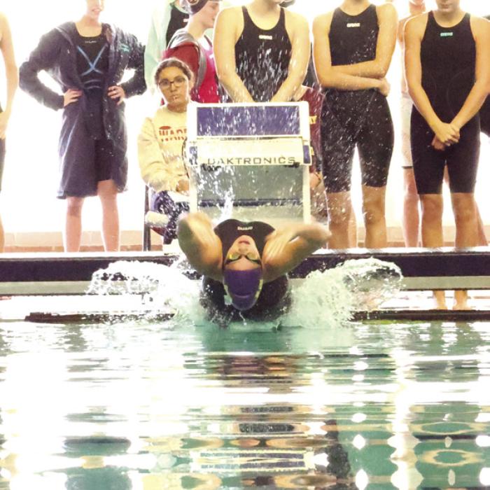 In the 100 Backstroke, La Grange senior Celeine Fabre, pictured above, broke a 2021 school record with a time of 1:17.02, cutting 1.33 seconds off the previous mark. Photo by Katy Michalke