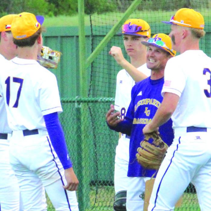La Grange head coach James Zaruba, in purple, is all smiles as he talks to his players between innings earlier this season.