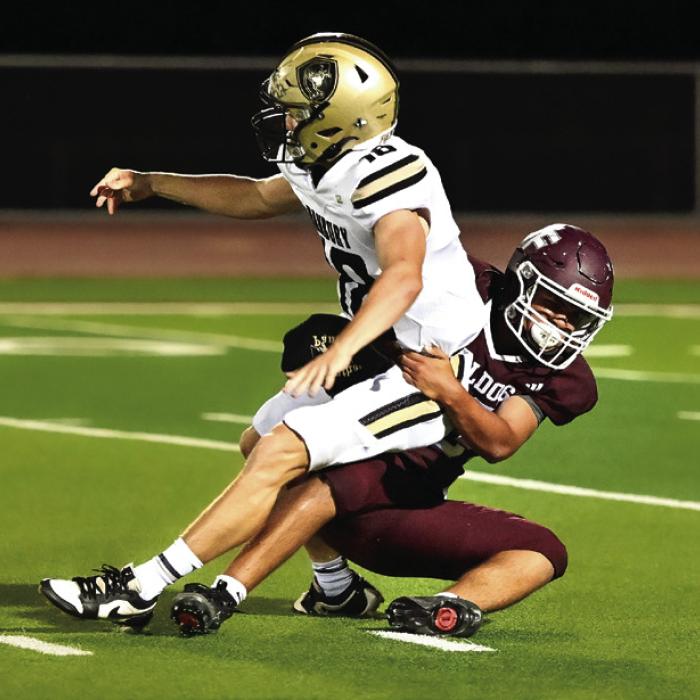 Photo by Stephanie Steinhauser Above: A host of Bulldogs consisting of Gabriel Aguillon (#56), Zayden Perez (#7) and Jose Garcia (#4) team up to stop Danbury offense. Left: Carmine Valdez brings down Danbury quarterback in the second half of Friday nights 32-12 win. Photos by Stephanie Steinhauser