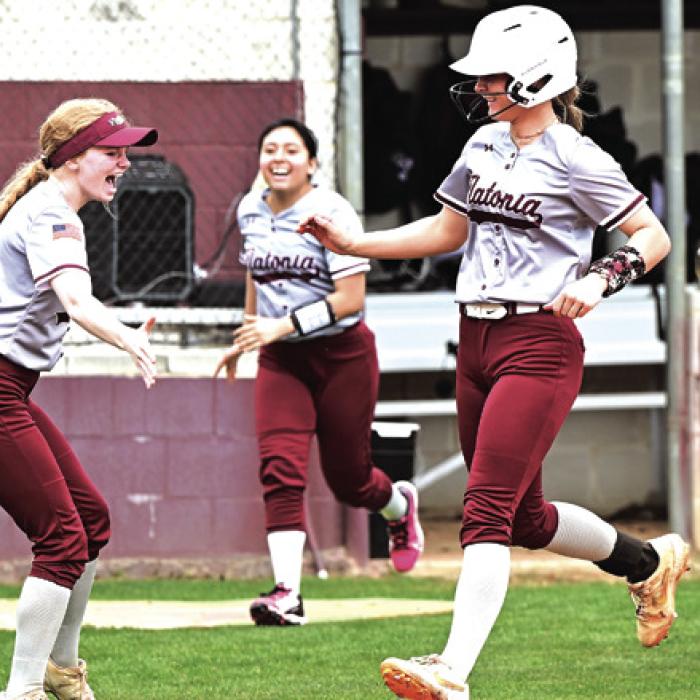 Flatonia’s Jalee Trussell celebrates her grand slam with catcher Dallyn Bishop as she crosses home plate Thursday at the Mike Schultze Softball Tournament in Flatonia. Despite Trussell’s heroics Yoakum beat Flatonia 11-6. Photo by Stephanie Steinhauser