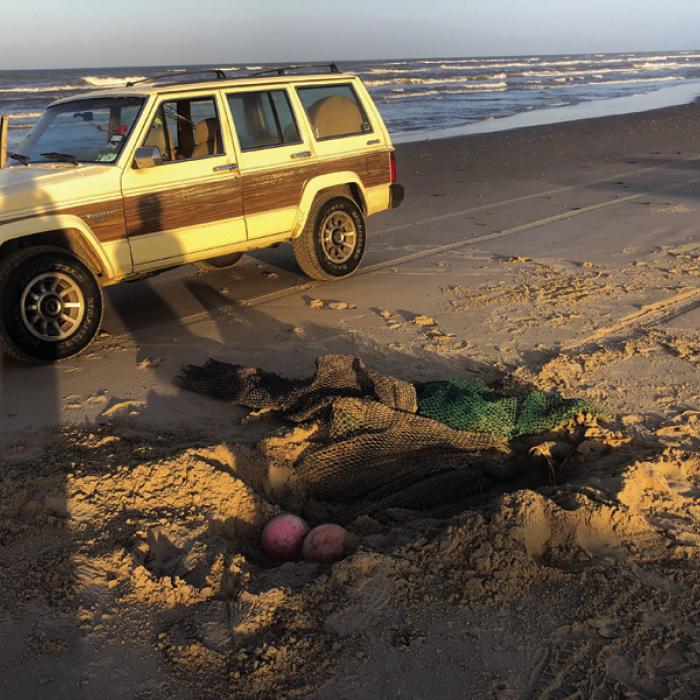 A few years go, Janessa and I found this big fishing net with glass floats burried in the sand on Padre Island National Seashore.