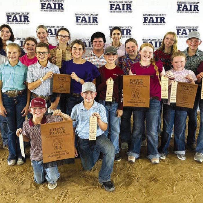 Front row kneeling from left: Joseph Carrales and Hudson Holu; second row: Cailee Daniel, Tate Fritsch, Adalyn Carrales, Crockett Guenther, Kaisley Janecka, Abigale McBride, and Abraham McBride; third row: Hunter Gabler, Laramie Laake, Tatum Fritsch, Logan Poncik, Brealey Nieto, Peyton Gilchrest, Holden Holub, and Coach Kaci Carrales Back Row: Coach JoJo Carrales, Addison Eichler, Hailey Janish, and Tori Newton.