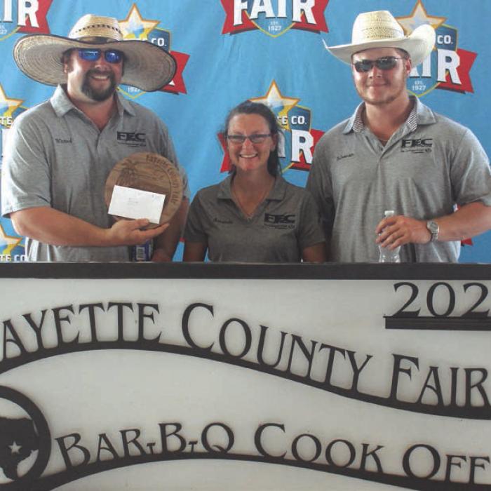 First Place Pork Butt – The “Linemen Who Cook” team of, left to right, Justin Whited, Amanda Whited and Mason Saleman.