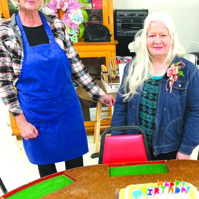March birthdays of the month are Julie Clements in the blue apron and Angie Pekar celebrating their birthday at the center.