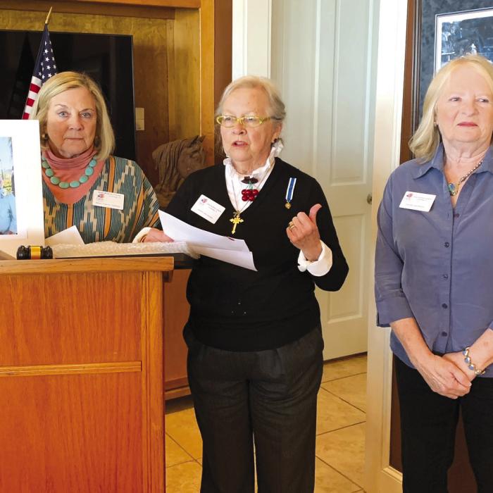 Pictured from left: Kathryn Callaway is holding a portrait of Kathy and Eldon Aydelotte; Sally Reynolds, Community Service Awards Chair; and Janet Murphy.