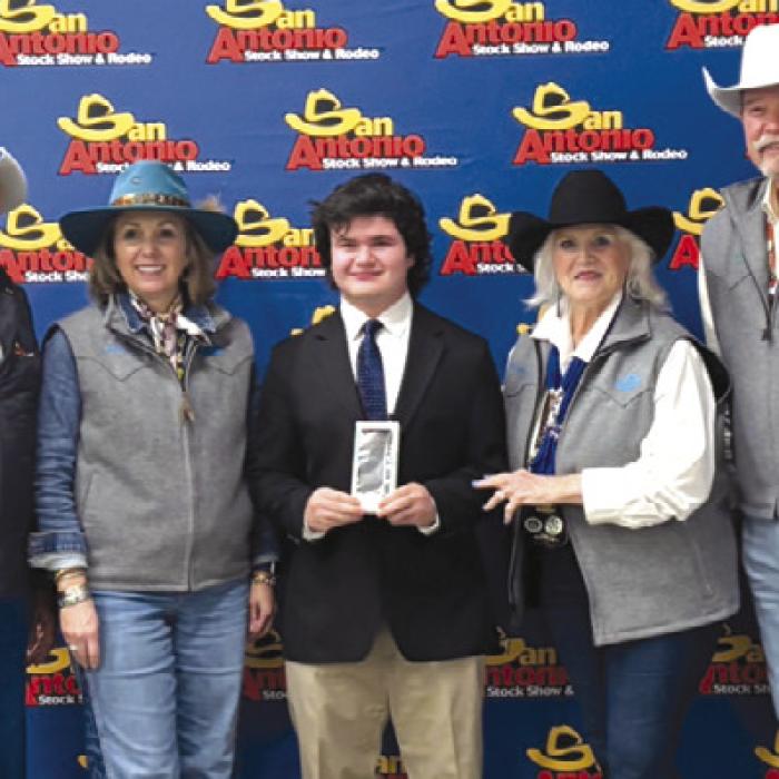 Senior Public Speaking: Logan Poncik, center with SALE Representatives.