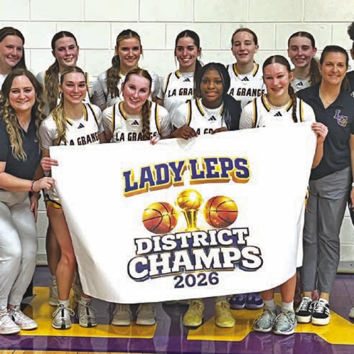 The members of the La Grange girls basketball team celebrate their district title at the conclusion of Tuesday’s win over Navasota. Photo by Jeff Wick