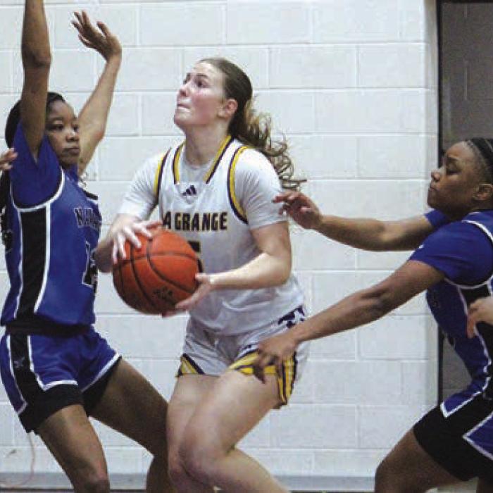 La Grange’s Campbell Cooper drives to the basket against some tough defense from Navasota Tuesday. Cooper scored a team-high 25 points.