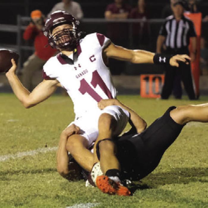 Ganado quarterback Bryce Ullman tosses the ball as he nearly gets sacked by Shorthorn defender Preston Kahn. The ball went out the back of the endzone, and officials ruled it a safety. Photo by Andy Behlen