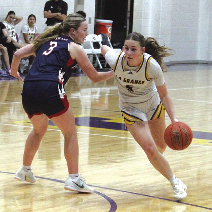 La Grange’s Campbell Cooper drives past Wimberley’s Bailey Whitten in last Tuesday’s game. Photo by Jeff Wick