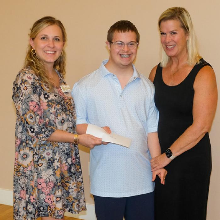 Brittany Siptak, left, presented a grant check to And Then a New Day, represented by Willy and Meg Keilbach.