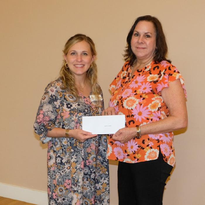 Brittany Siptak, left, presented a grant check to the Bugle Boy Foundation, representated by Joni Westall.
