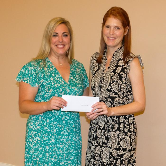Jamie Murphy, left, presented a grant check to Fayette County Community Theater, represented by Melanie Lira.