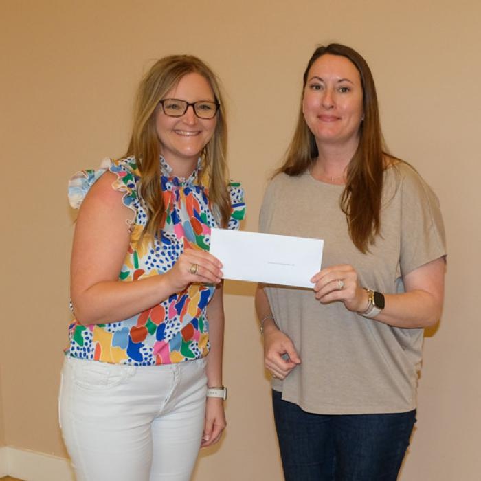 Kristen Vandever, left, presented a grant check to Combined Community Action, represented by Marissa Anderson.