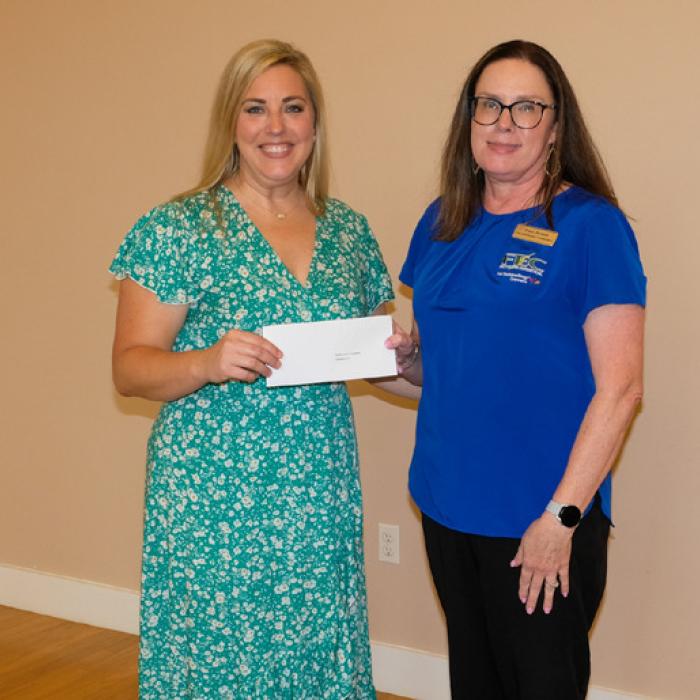 Jamie Murphy, left, presented a grant check to Fayette Electric Cooperative Charitable Fund, represented by Tracey Denton.