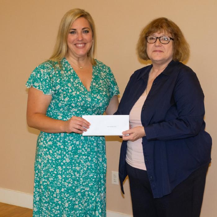 Jamie Murphy, left, presented a grant check to Faison Preservation Society, represented by Katy Beauford.