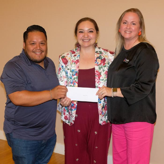 Nicole Gabler, center, presented a grant check to Parents as Teachers of Rural Central Texas, represented by Josue Rivas and Kristi McBride.