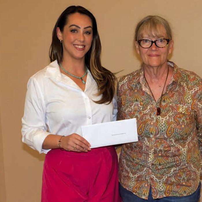 Samantha Mikulin, left, presented a grant check to Schulenburg Library Foundation, represented by Cindy Lytle.