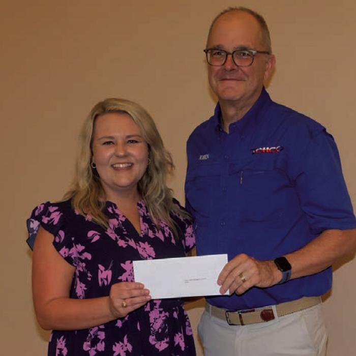 Tiffany Surman, left, presented a grant check to the Texas Czech Heritage and Cultural Center, represented by John Bartos.