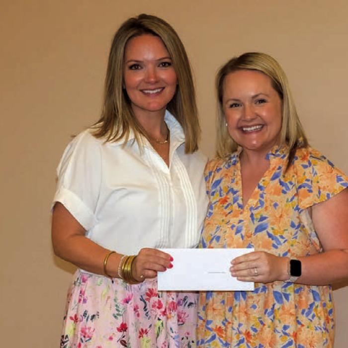 Randi Willis, right, presented a grant check to Round Top Family Library, represented by Katey Crowley.