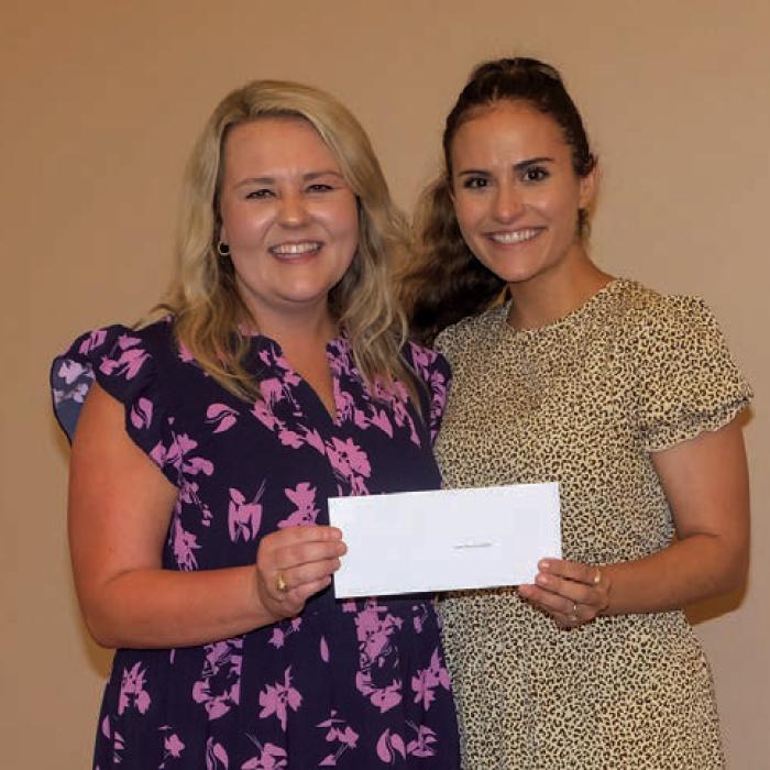 Tiffany Surman, left, presented a grant check to Turtle Wing Foundation, represented by Destiny Siptak.