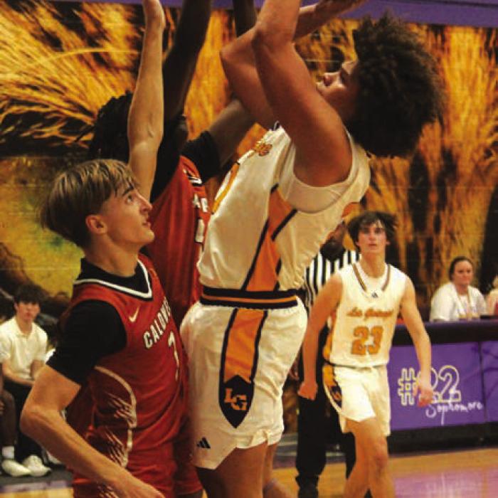 La Grange’s Devonte McKenzie goes to the basket as two Caldwell players defend on the play Friday. Photo by Jeff Wick